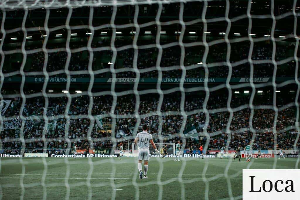 man standing on green soccer field